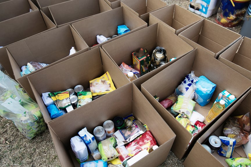 Cardboard boxes being filled with food donations